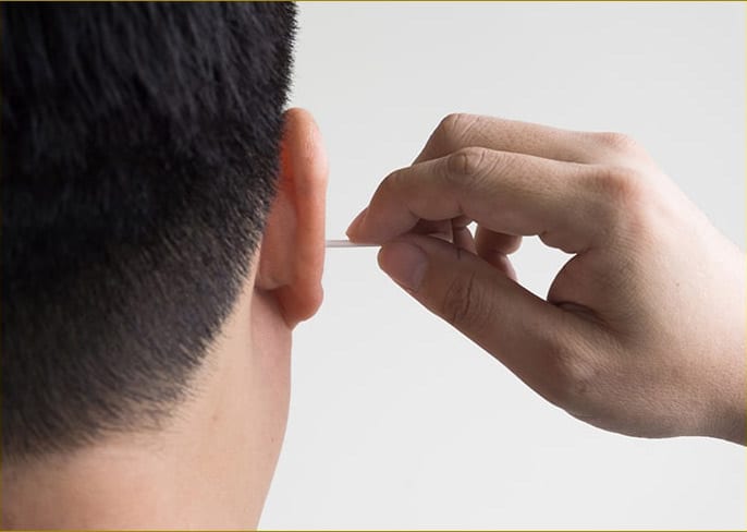 Man cleaning his ear in conventional way